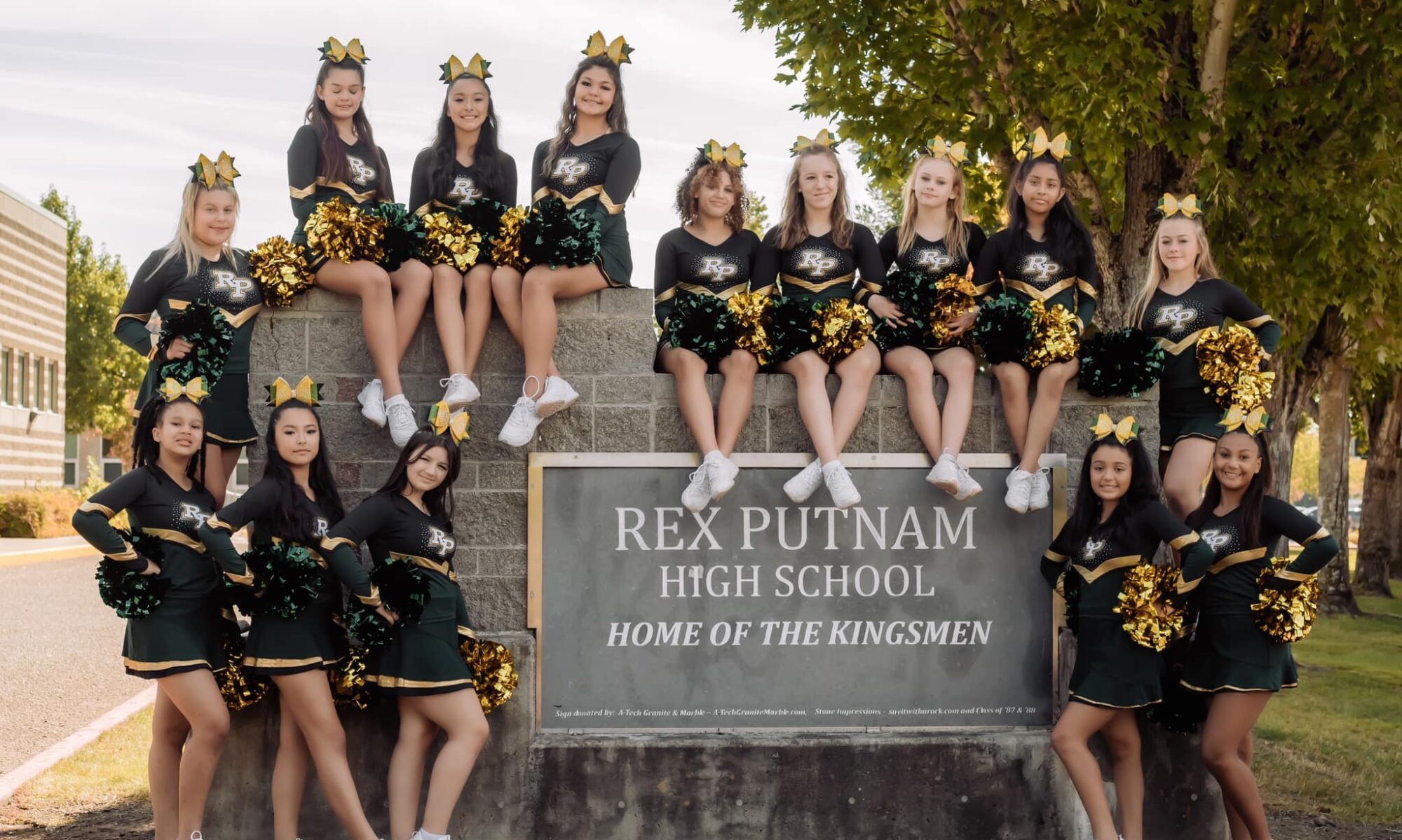 The RPYC team sits on the entrance sign to Rex Putnam.